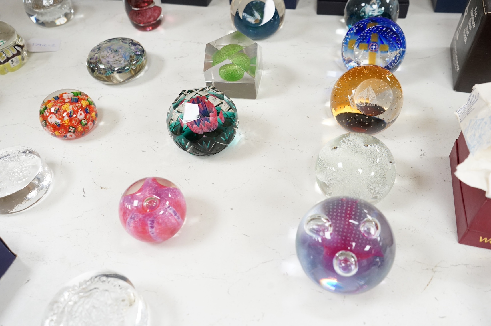 A collection of twenty seven glass paperweights some boxed, to include Caithness and Wedgwood, largest 12cm high. Condition - mostly good